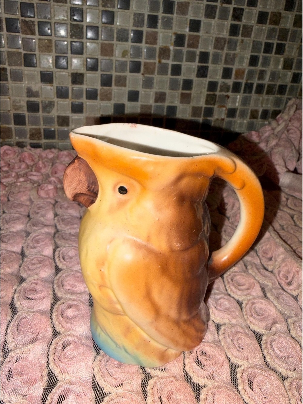 This is a 1930s Czechoslovakian Art Deco ceramic cockatoo pitcher.